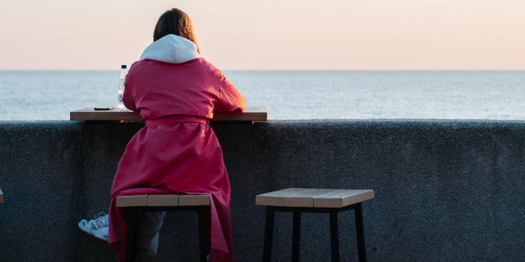 young woman sitting alone
