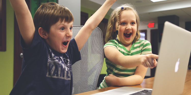 childrens staring at laptop