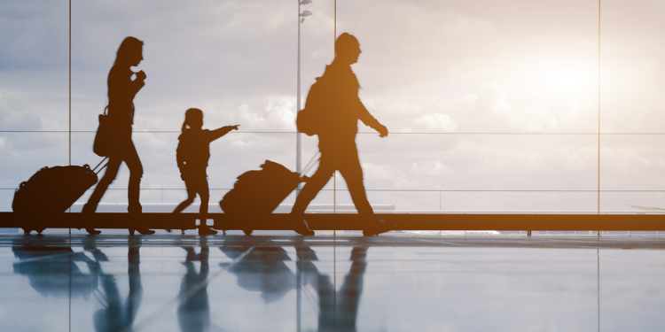 young family with luggage walking at airpor