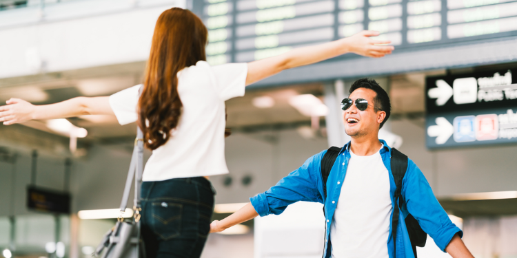 happy couple reuniting at airport