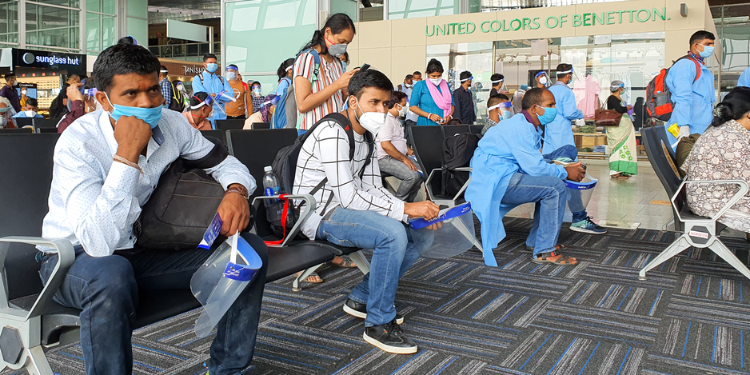 6th June 2020- Netaji Subhas Chandra Bose International Airport, Calcutta, India-Travelers maintaining social distancing in protective gear before boarding flight at airport