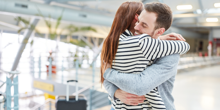 couple hugging at airport