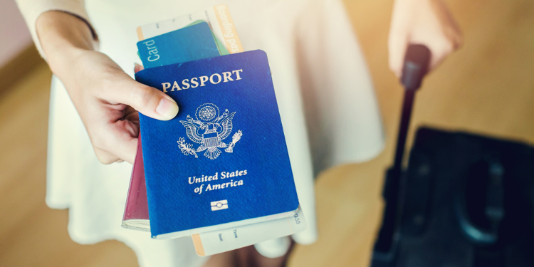 young woman holding passports