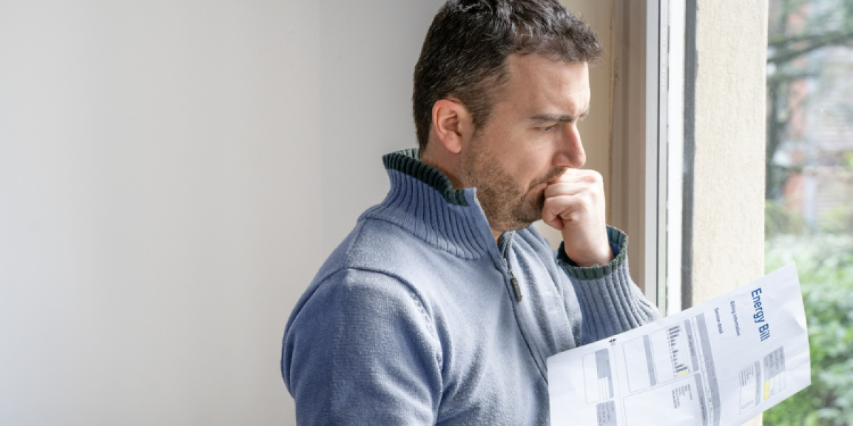 man holding energy bill