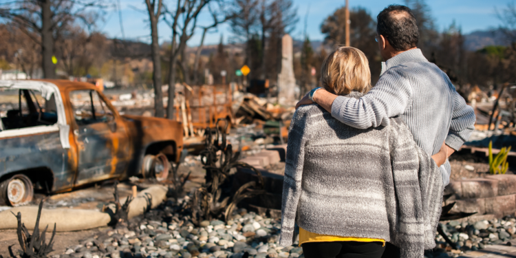couple looking at damage after natural disaster