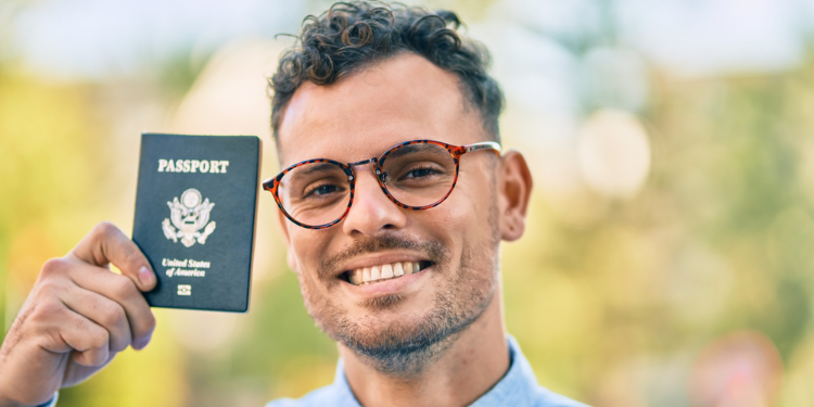 young man holding passport