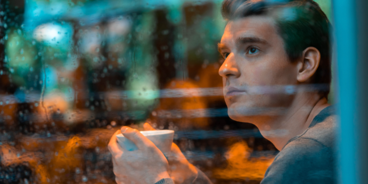 young man alone at cafe
