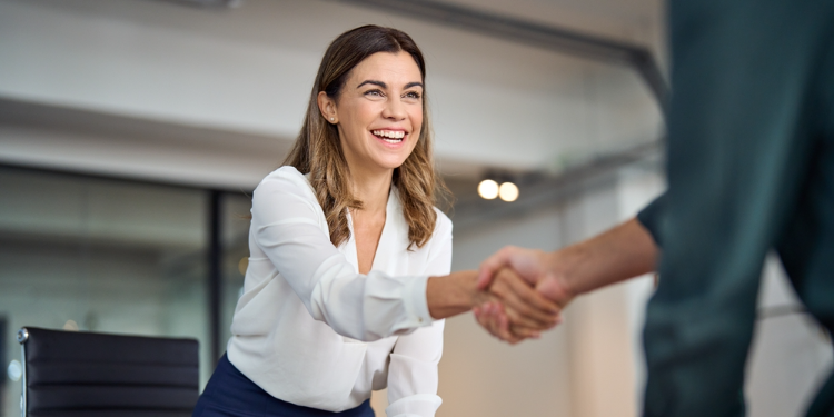 business woman smiling and shaking hands