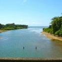A view in Dominical where the Barú River meets the Pacific Ocea
