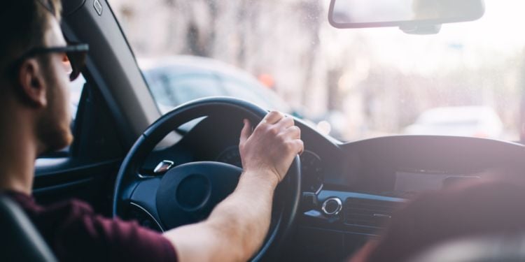 man driving a car