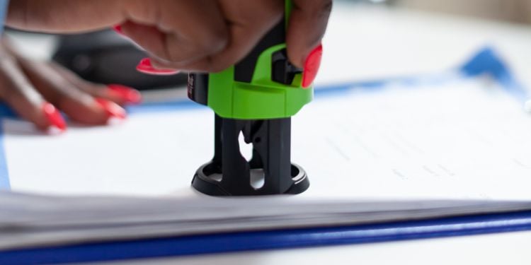 person stamping documents