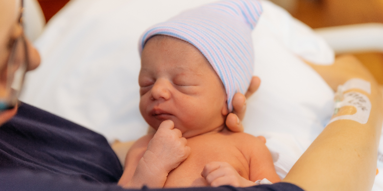 newborn in his mother's arms at hospital
