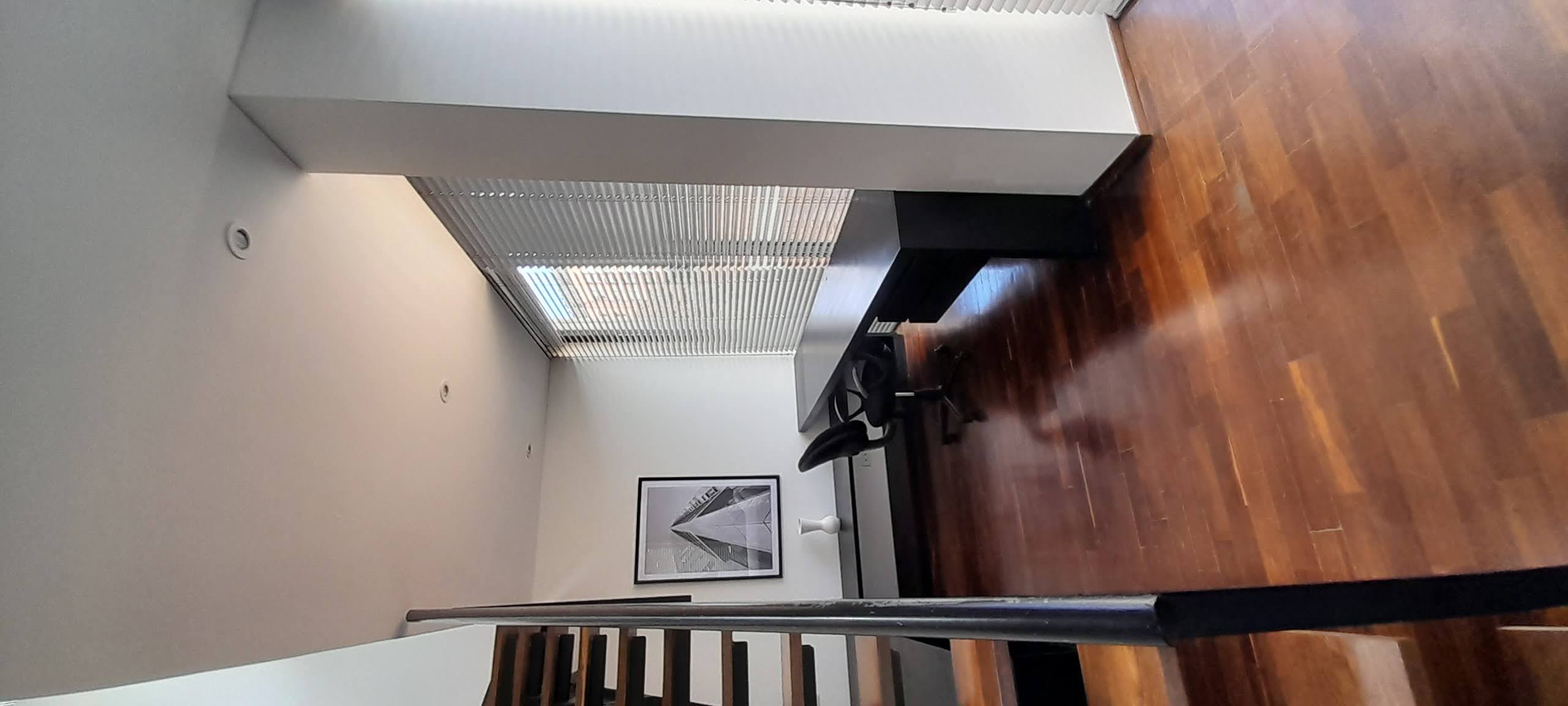 Modern duplex loft with open kitchen, living room, study, bathroom with tub, king bedroom, panoramic terrace and natural wood finishes.